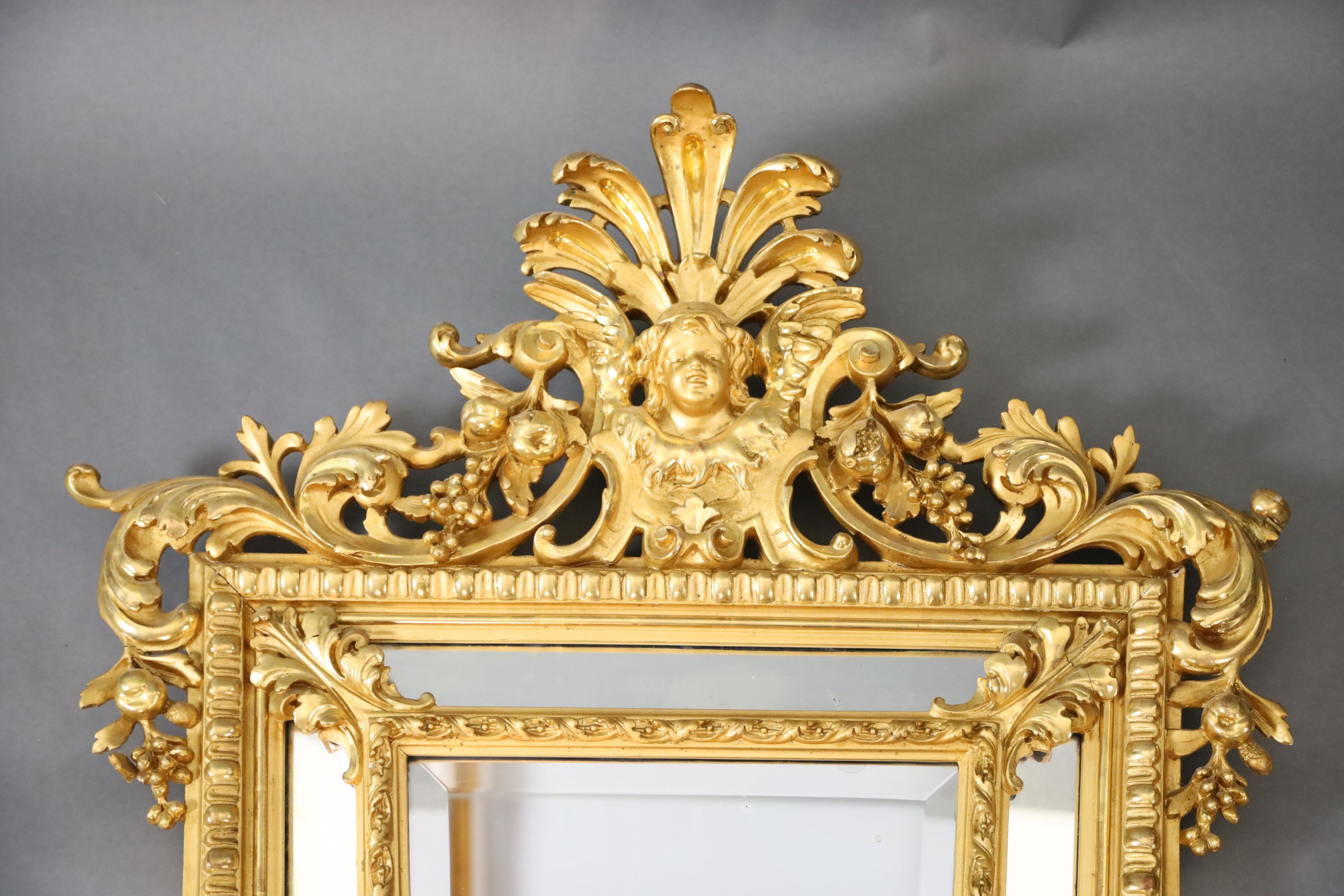 A Louis XIV style carved giltwood wall mirror, W.3ft 1in. H.5ft 1in.